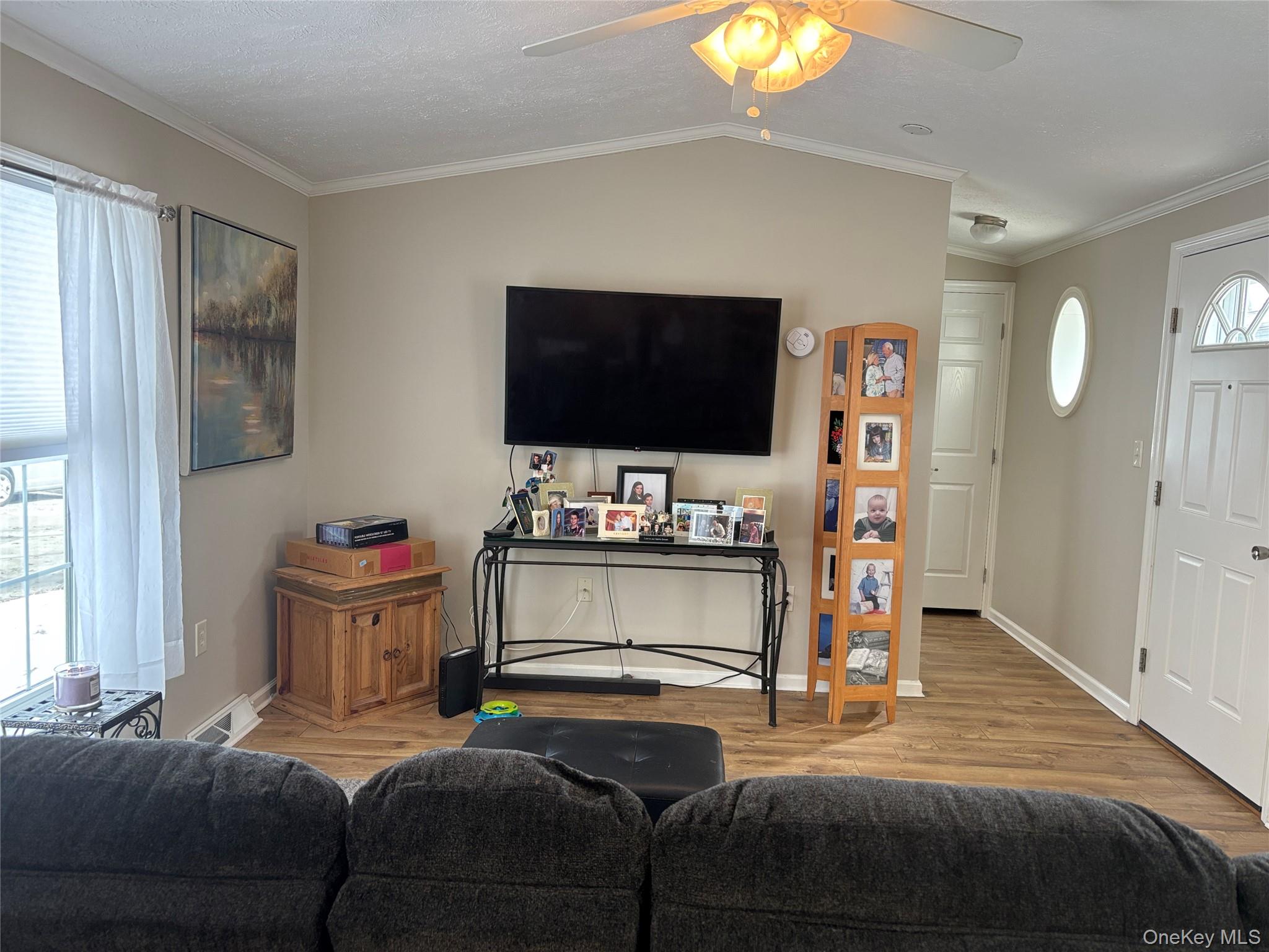 1661 Old Country Road, Unit 69 Riverhead, NY 11901 - Photo 16 of 37 a bedroom with furniture and a flat screen tv