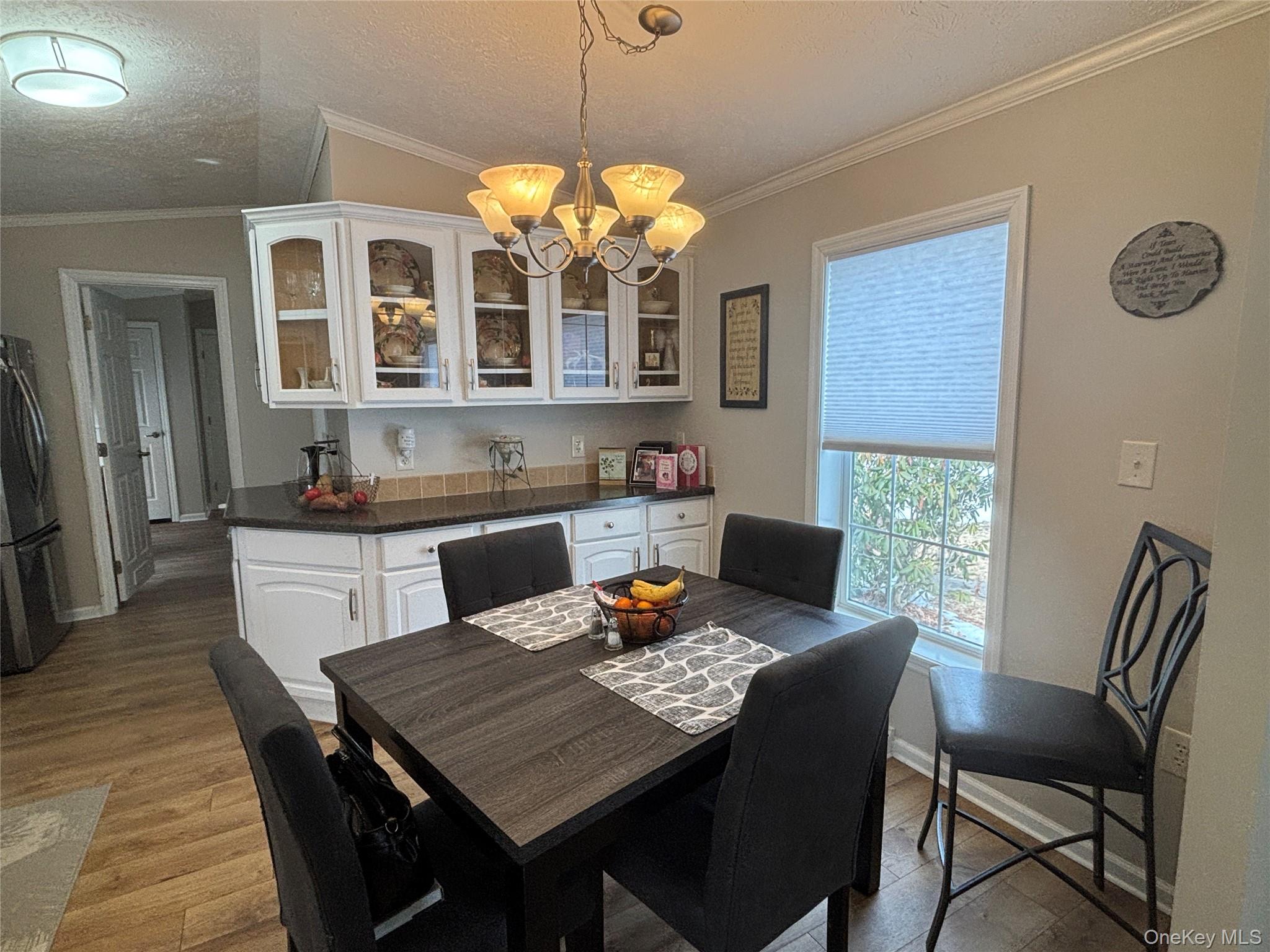 1661 Old Country Road, Unit 69 Riverhead, NY 11901 - Photo 19 of 37 a view of a dining room with a table and chairs