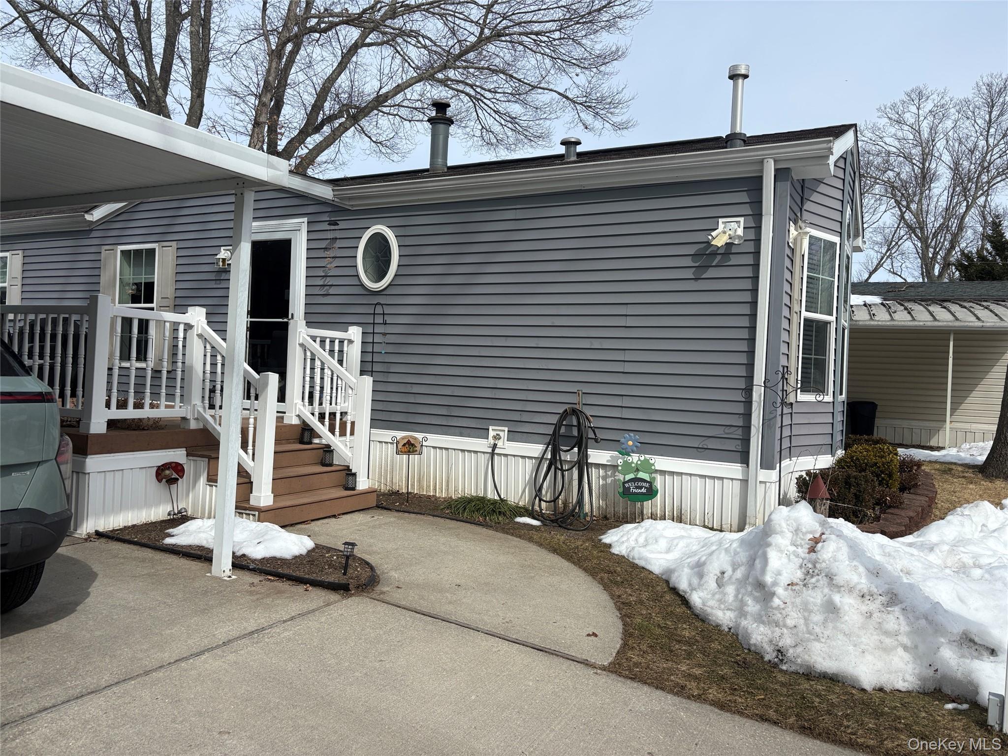 1661 Old Country Road, Unit 69 Riverhead, NY 11901 - Photo 2 of 37 a view of a house with a patio and a yard
