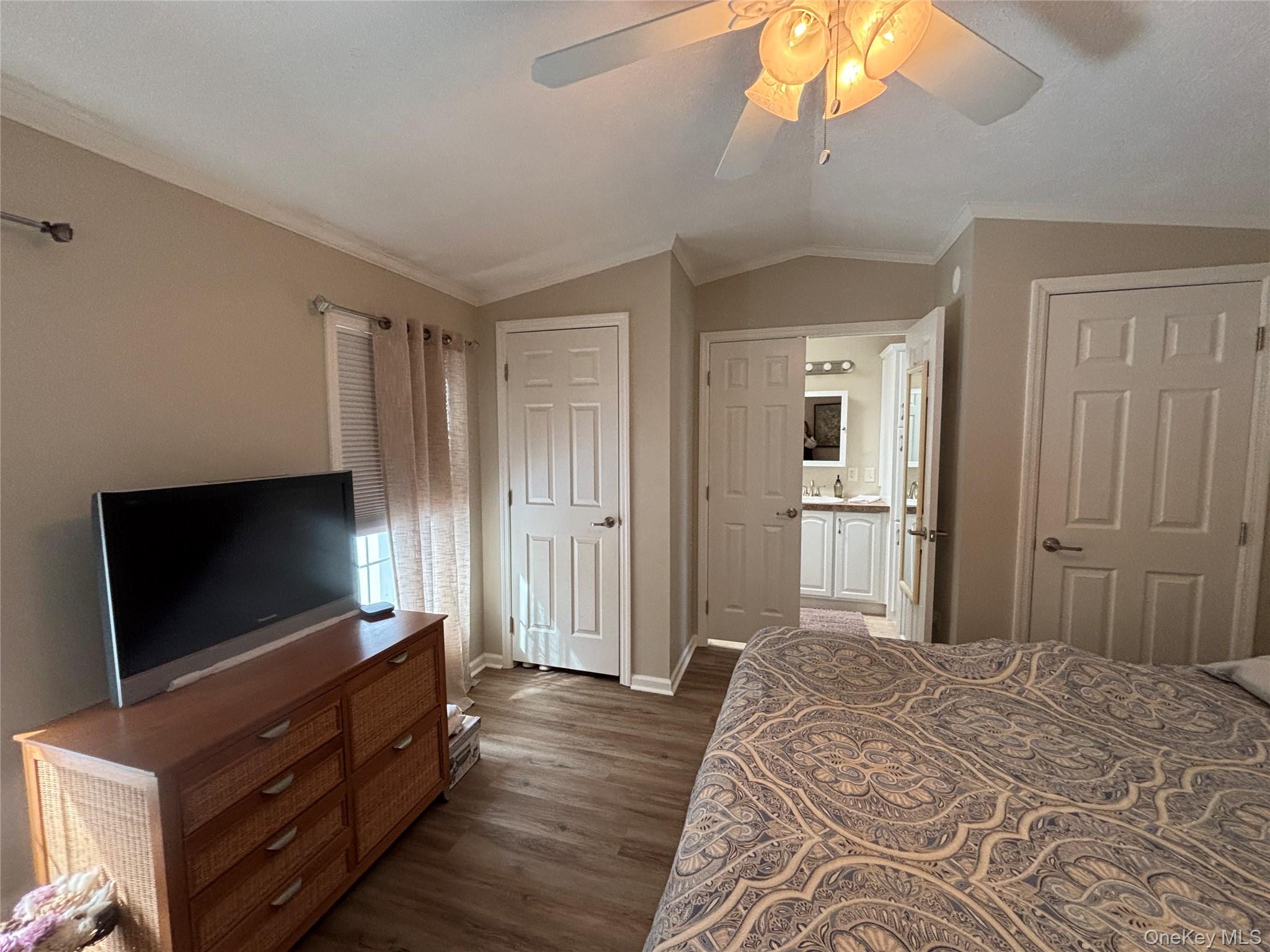 1661 Old Country Road, Unit 69 Riverhead, NY 11901 - Photo 23 of 37 a bedroom with bed and flat screen tv