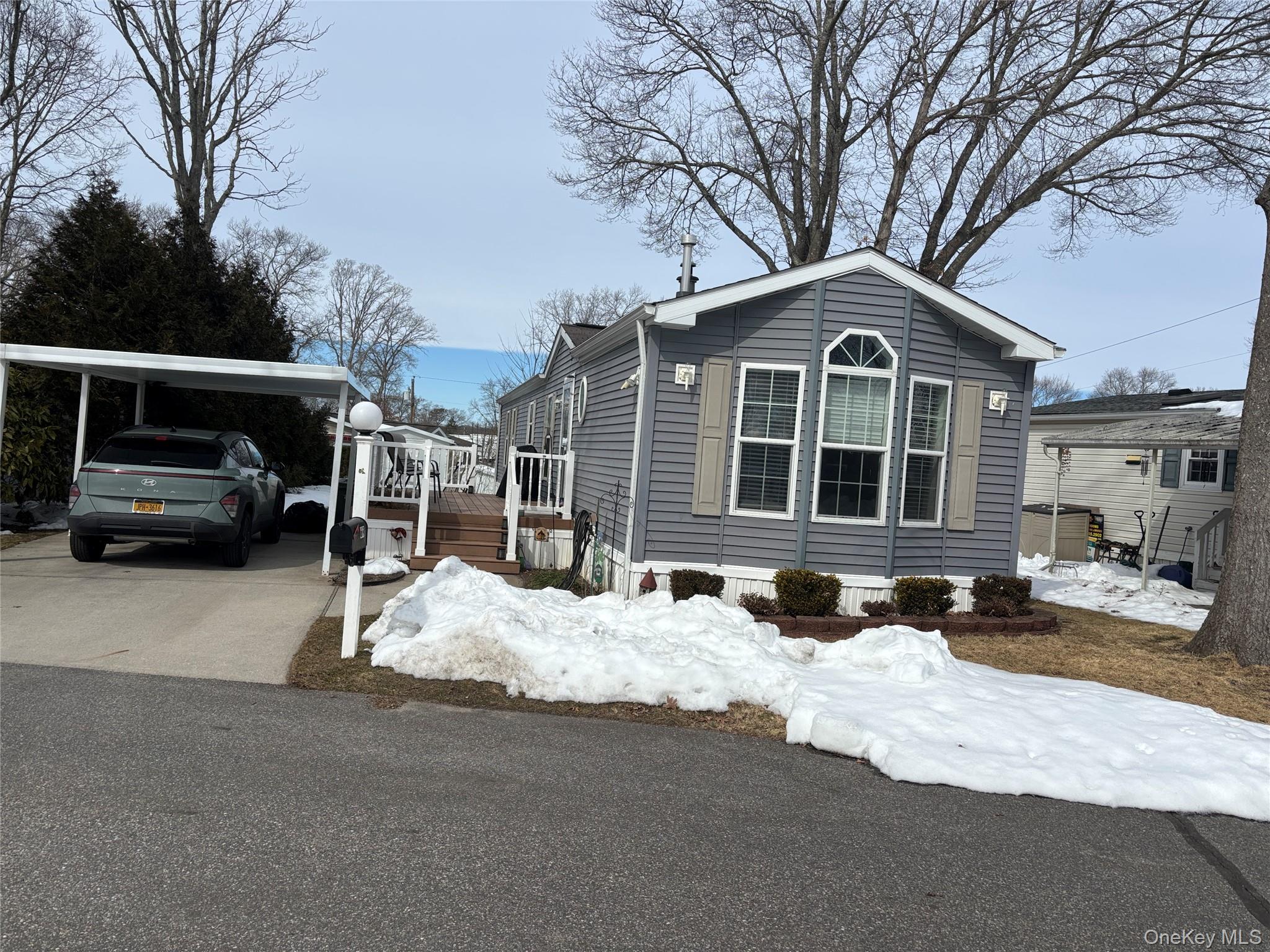 1661 Old Country Road, Unit 69 Riverhead, NY 11901 - Photo 27 of 37 a front view of a house with cars parked