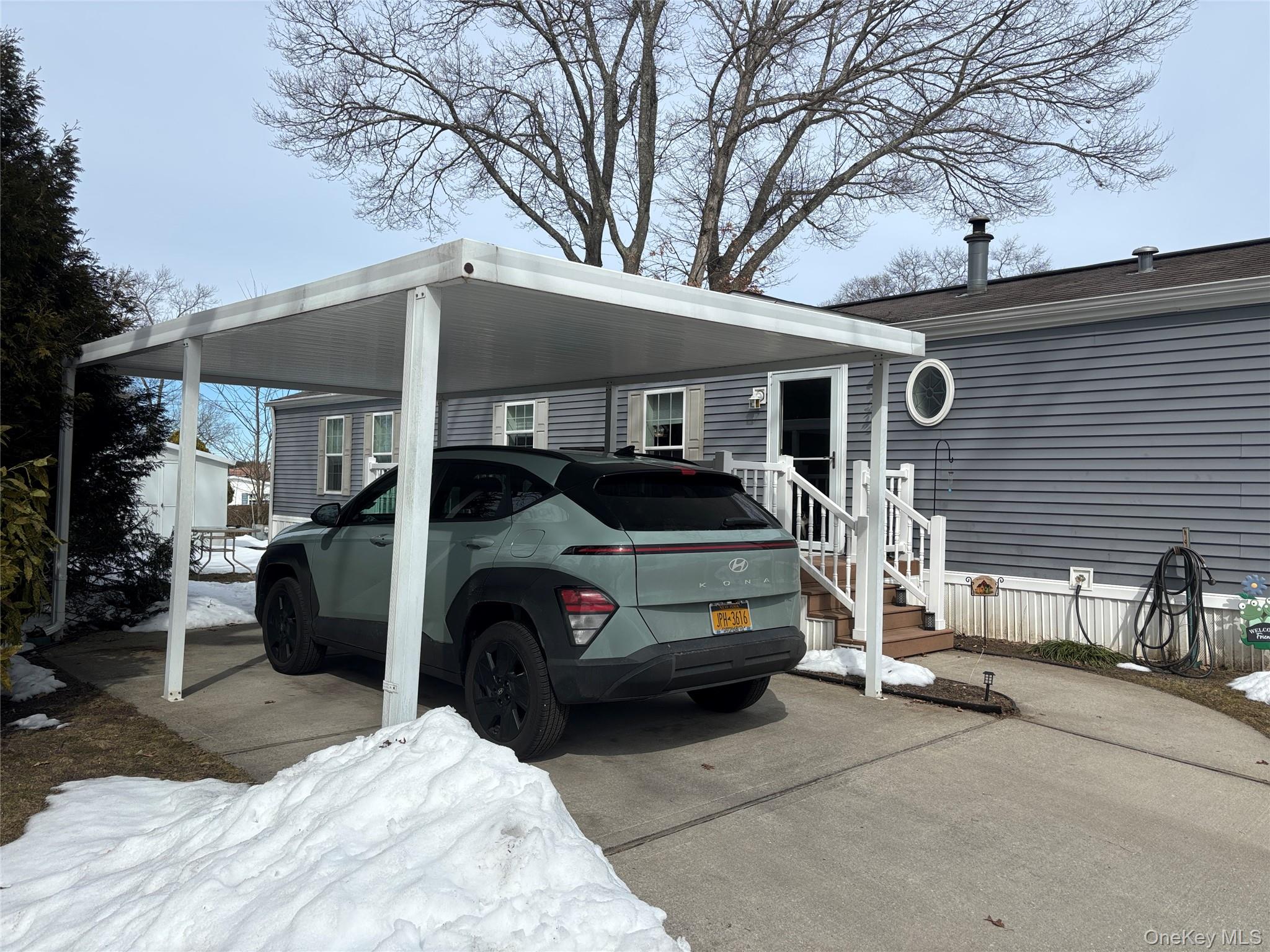 1661 Old Country Road, Unit 69 Riverhead, NY 11901 - Photo 3 of 37 a car parked in front of a white house