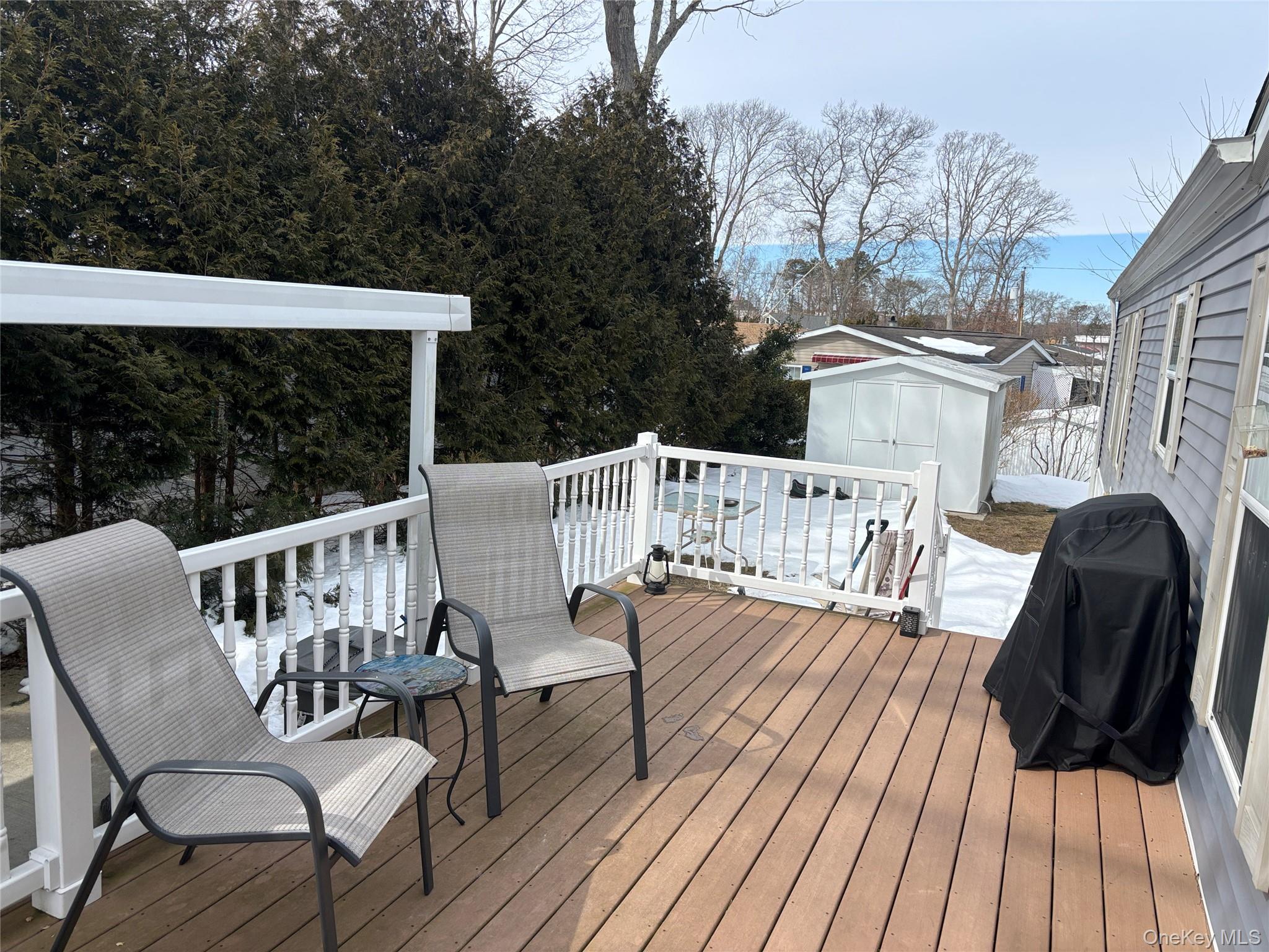 1661 Old Country Road, Unit 69 Riverhead, NY 11901 - Photo 5 of 37 a view of a chairs in wooden deck