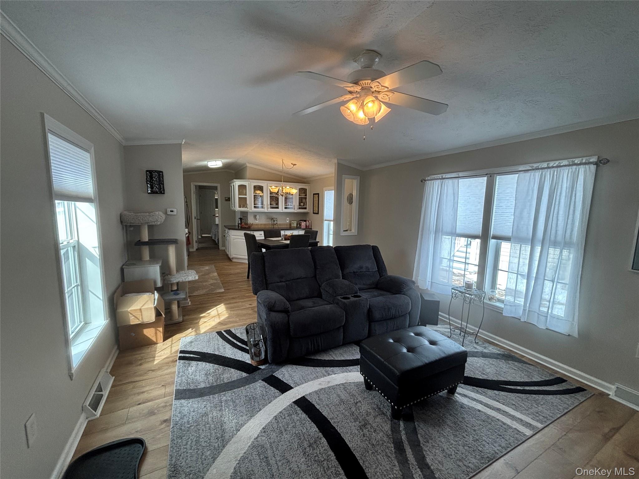 1661 Old Country Road, Unit 69 Riverhead, NY 11901 - Photo 6 of 37 a living room with furniture and a large window