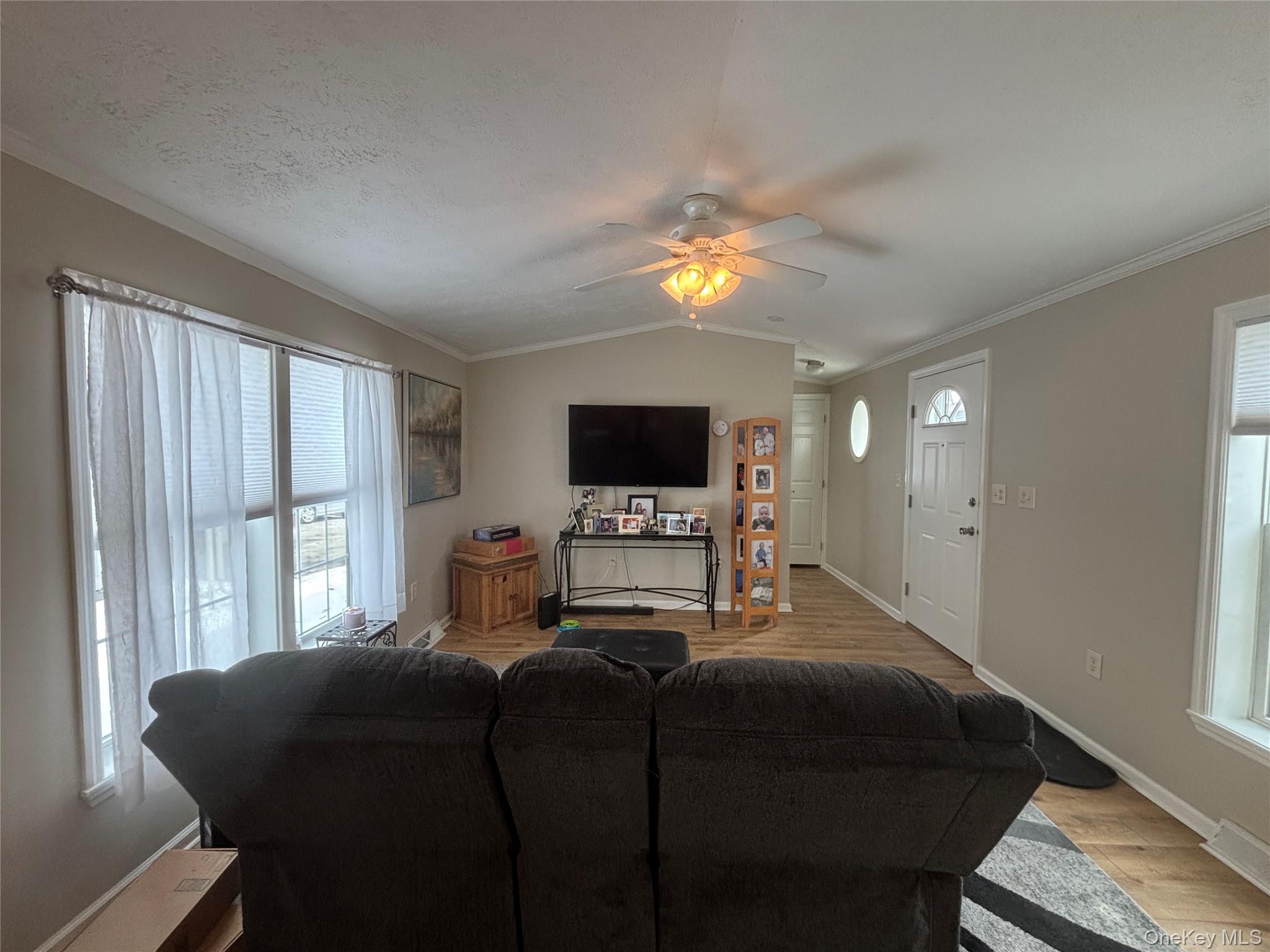 1661 Old Country Road, Unit 69 Riverhead, NY 11901 - Photo 7 of 37 a bedroom with a bed and a flat screen tv