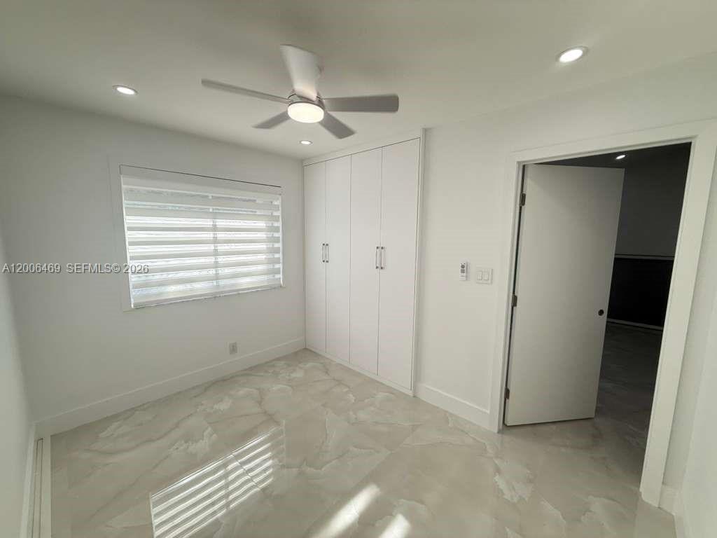 9307 Southwest 138th Place, Unit 9307 Miami, FL 33186 - Photo 11 of 15 a view of an empty room with a window