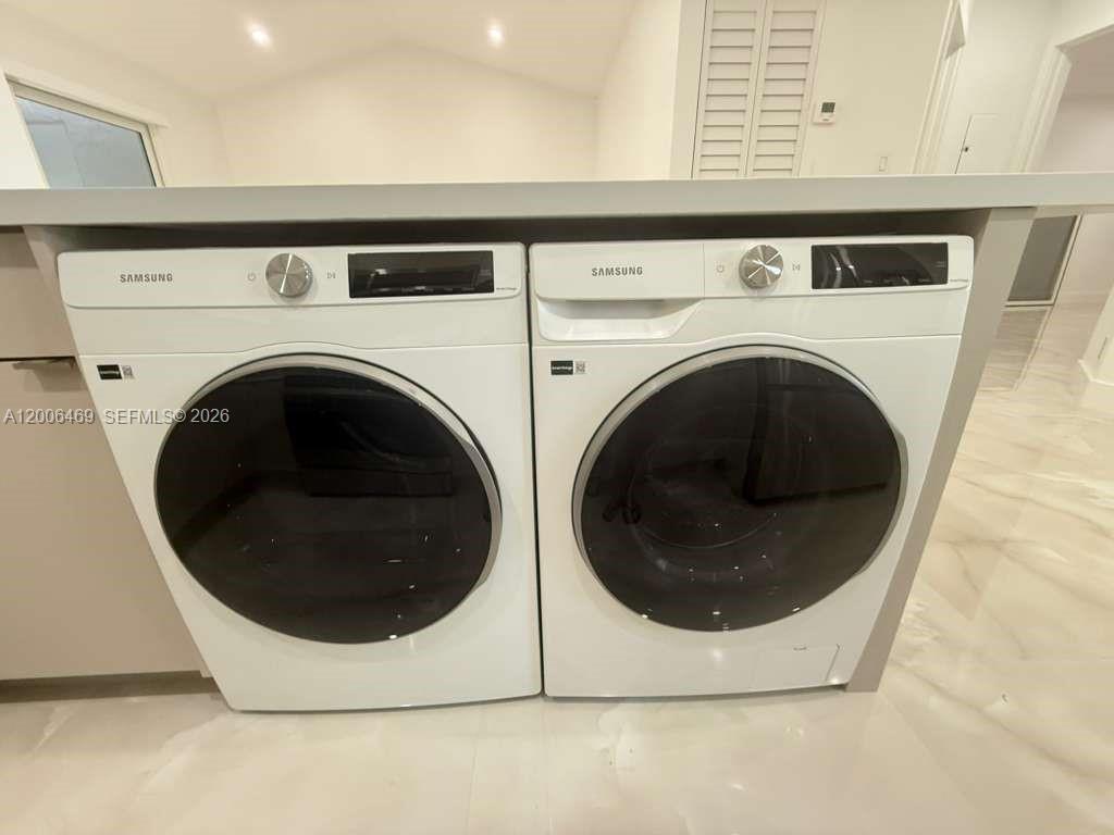 9307 Southwest 138th Place, Unit 9307 Miami, FL 33186 - Photo 12 of 15 a utility room with dryer and washer
