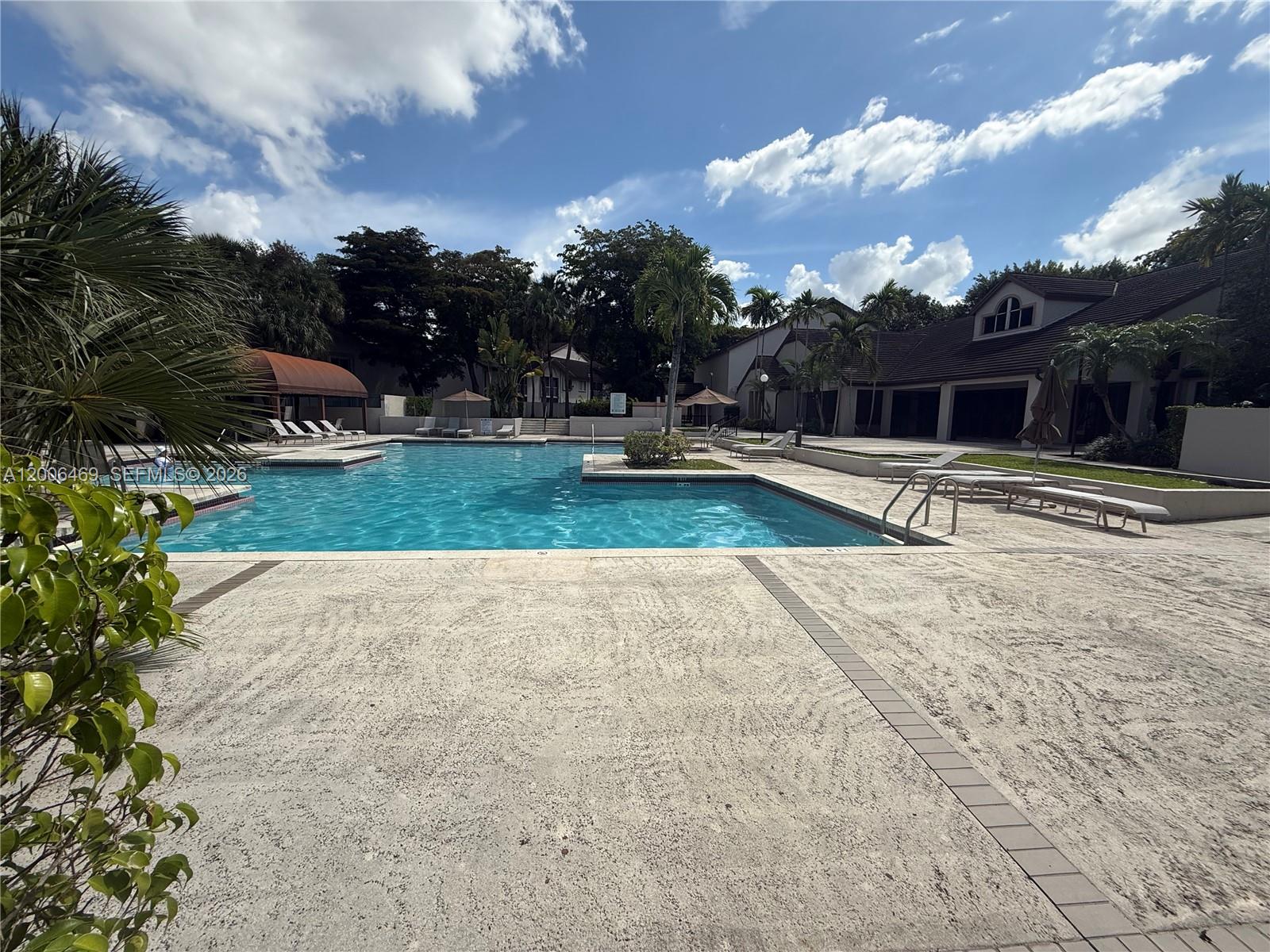 9307 Southwest 138th Place, Unit 9307 Miami, FL 33186 - Photo 15 of 15 a view of a yard with patio