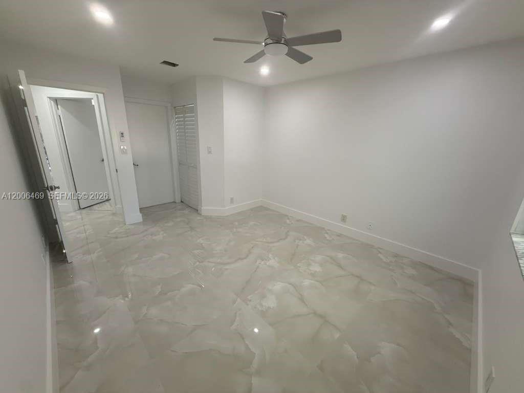 9307 Southwest 138th Place, Unit 9307 Miami, FL 33186 - Photo 7 of 15 wooden floor in an empty room