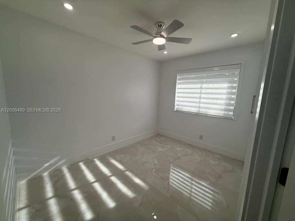 9307 Southwest 138th Place, Unit 9307 Miami, FL 33186 - Photo 10 of 15 a view of an empty room with a window