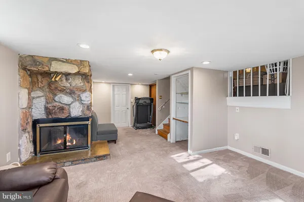 a view of a livingroom with a fireplace and workspace