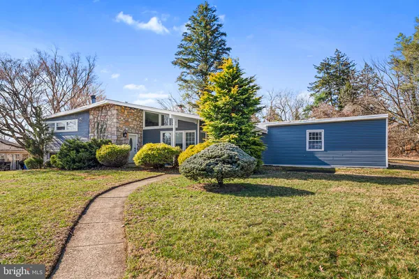 a large tree in front of a house