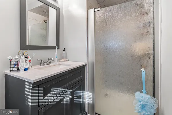 a bathroom with a sink vanity and a mirror