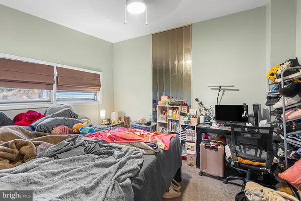 a bedroom with bed and a tv