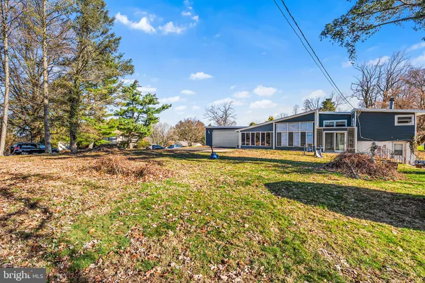 a house view with swimming pool in front of it