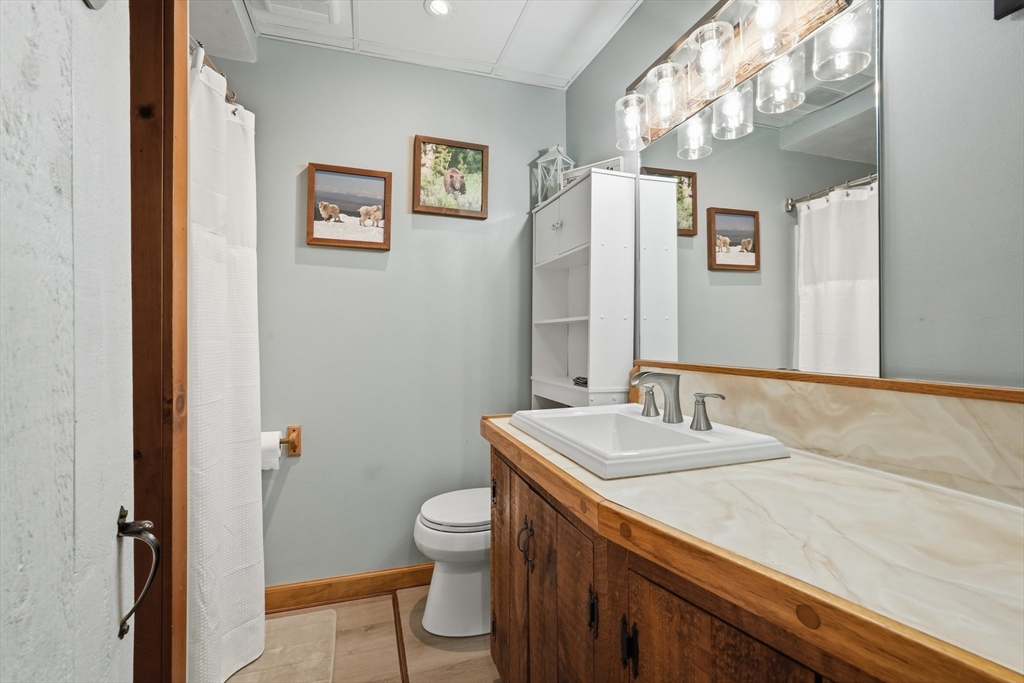 136 Flynt Street Palmer, MA 01069 - Photo 12 of 28 a bathroom with a granite countertop sink a toilet and a mirror