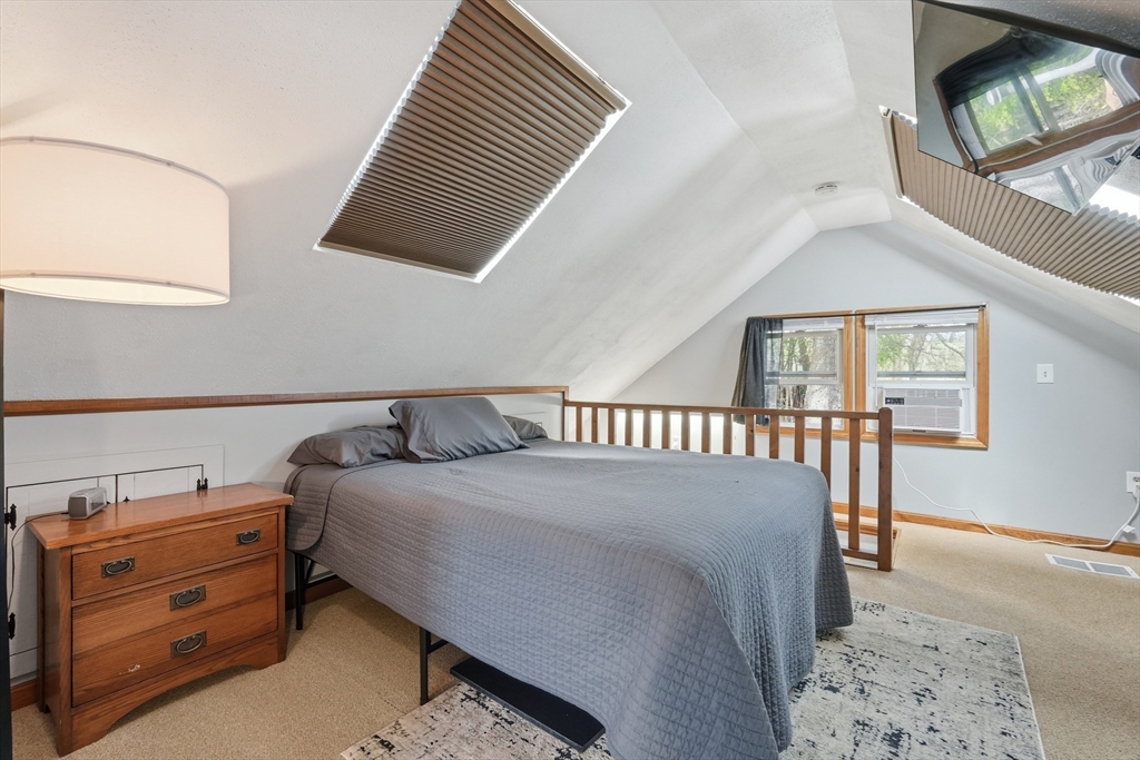 136 Flynt Street Palmer, MA 01069 - Photo 14 of 28 a bed sitting in a bedroom next to a window