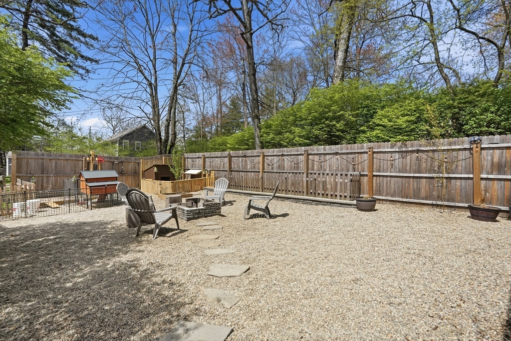 136 Flynt Street Palmer, MA 01069 - Photo 19 of 28 a view of backyard with table and chairs and wooden fence