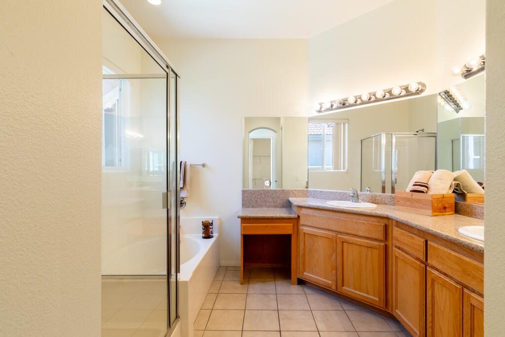 49635 Wayne Street Indio, CA 92201 - Photo 11 of 21 a spacious bathroom with a double vanity sink a mirror and a bathtub