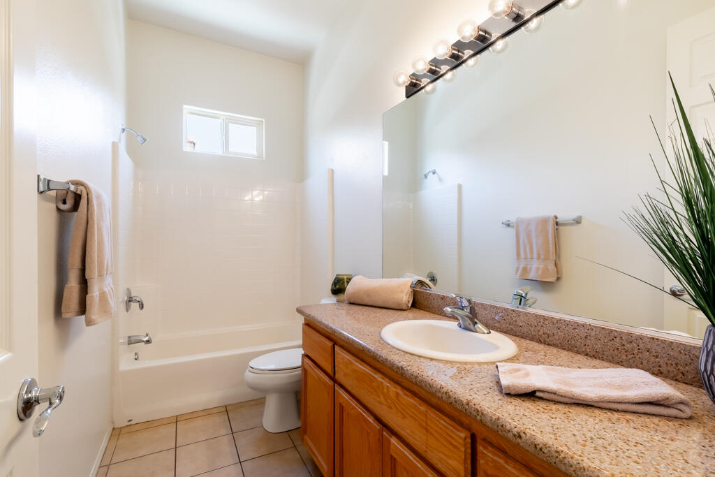 49635 Wayne Street Indio, CA 92201 - Photo 14 of 21 a bathroom with a granite countertop sink a toilet and shower