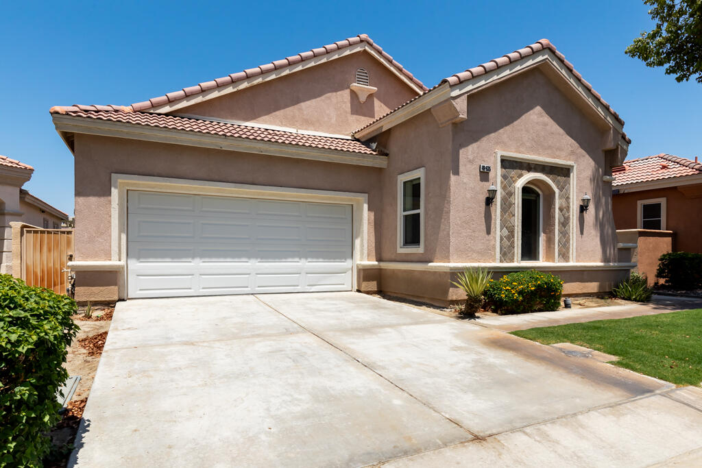 49635 Wayne Street Indio, CA 92201 - Photo 2 of 21 a front view of a house with a yard