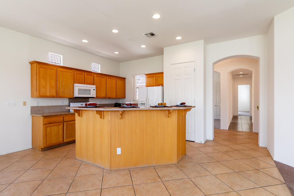 49635 Wayne Street Indio, CA 92201 - Photo 3 of 21 a view of kitchen with stainless steel appliances granite countertop a refrigerator and a stove top oven