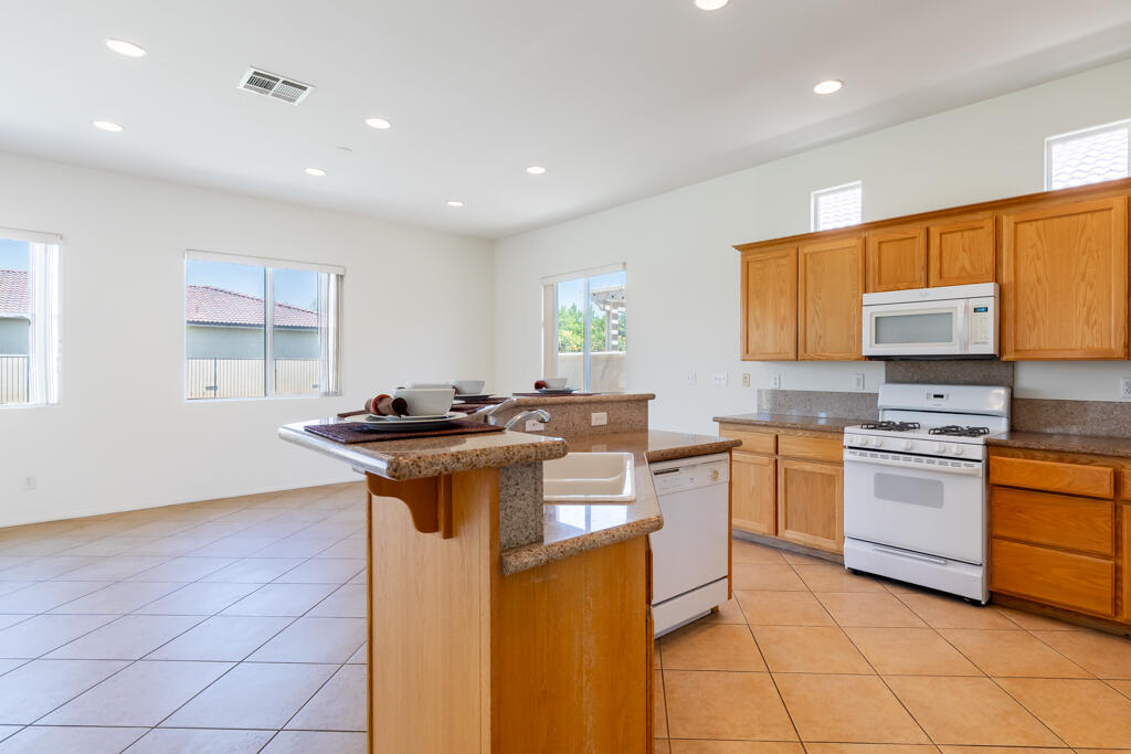 49635 Wayne Street Indio, CA 92201 - Photo 4 of 21 a kitchen with stainless steel appliances granite countertop a sink stove and refrigerator