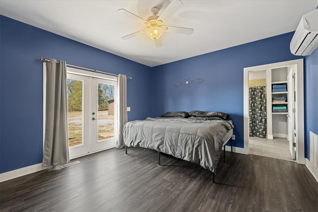 212 Winding Lane Seneca, SC 29672 - Photo 14 of 47 This serene bedroom offers direct outdoor access and modern comforts for ultimate relaxation.