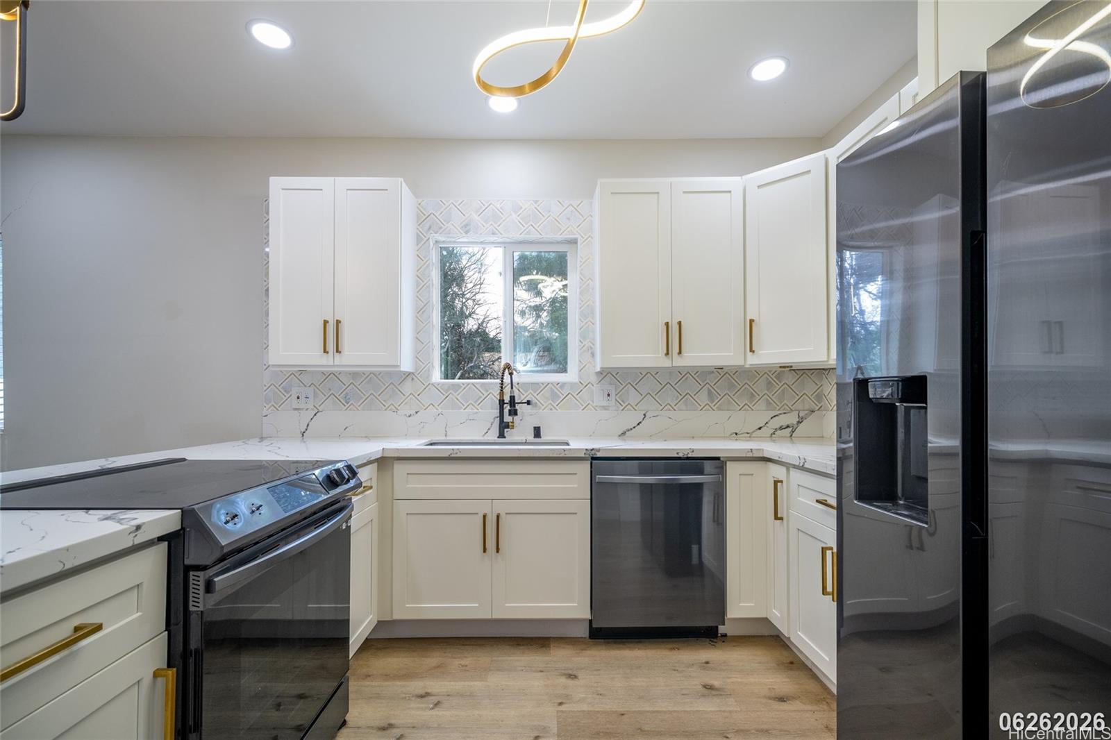 87-1409 Akowai Road Waianae, HI 96792 - Photo 14 of 25 a kitchen with a sink stove and refrigerator