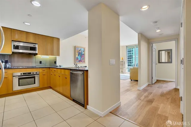 a kitchen with granite countertop a stove and a refrigerator
