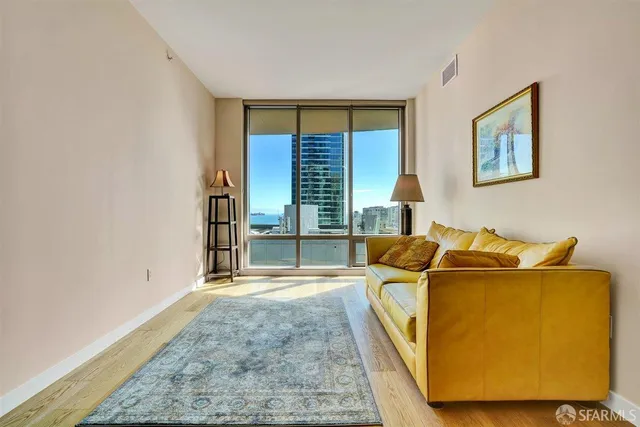 a living room with furniture and a floor to ceiling window