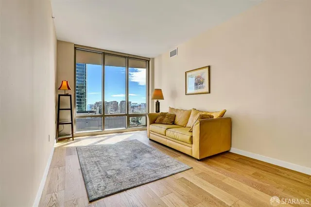 a living room with furniture a piano and a window