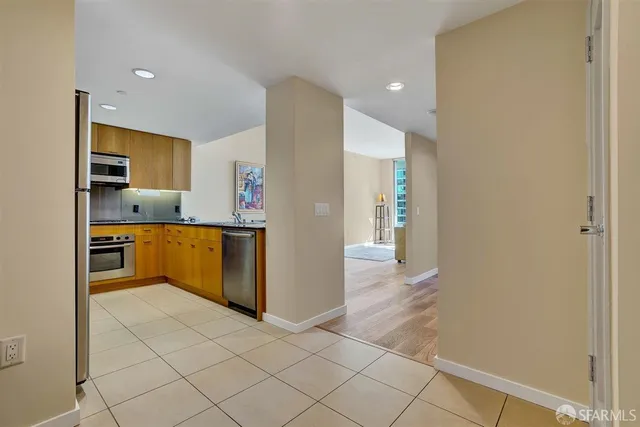 a kitchen with a refrigerator and a stove top oven