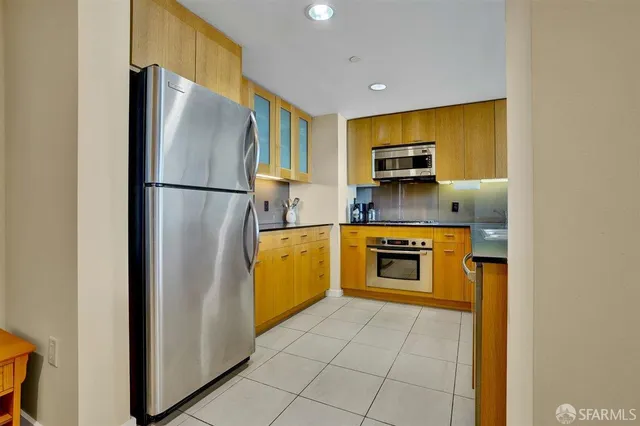 a kitchen with stainless steel appliances granite countertop a stove and a microwave