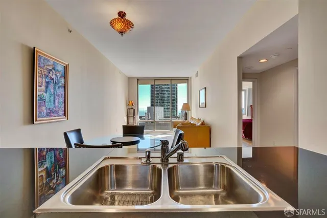 a kitchen with stainless steel appliances granite countertop a sink and a stove