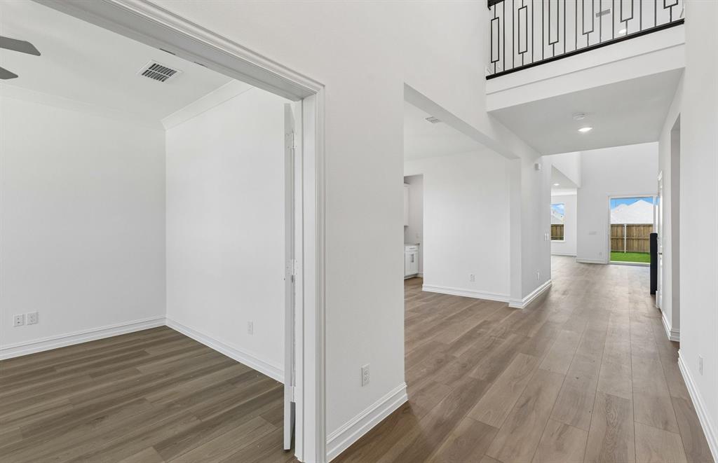 11220 Abbotsbury Road Fort Worth, TX 76052 - Photo 2 of 32 a view of a hallway with wooden floor