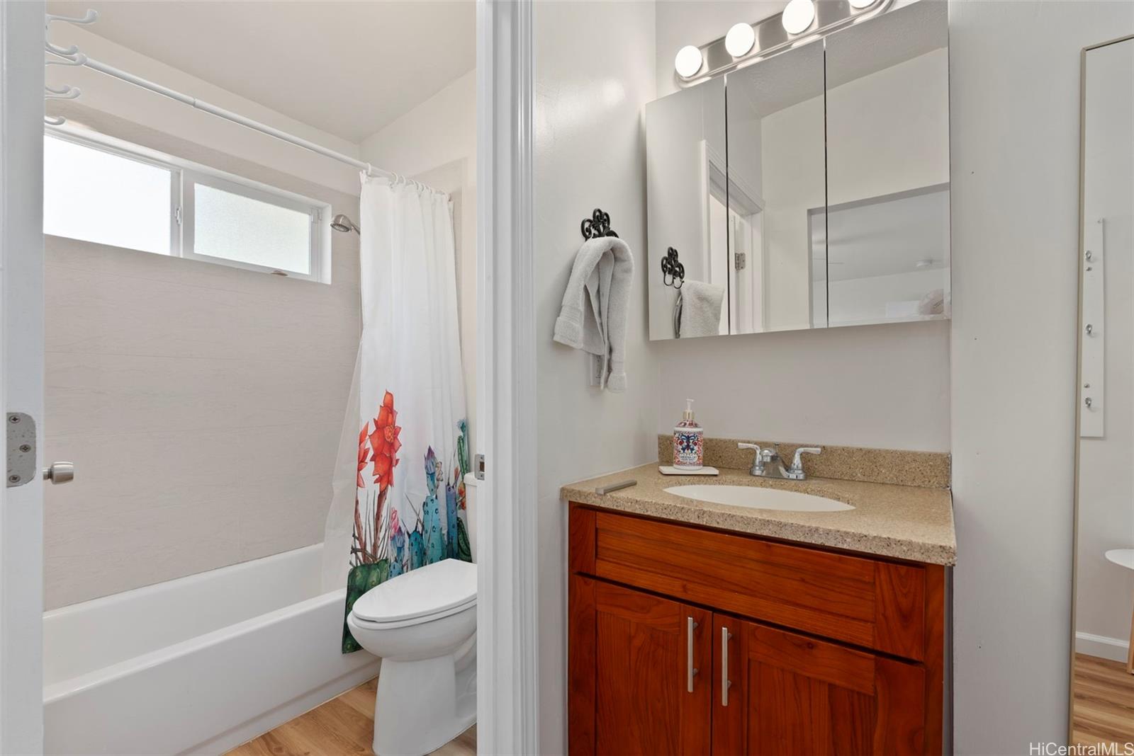 87-1423 Akowai Road Waianae, HI 96792 - Photo 11 of 24 a bathroom with a sink a toilet and shower