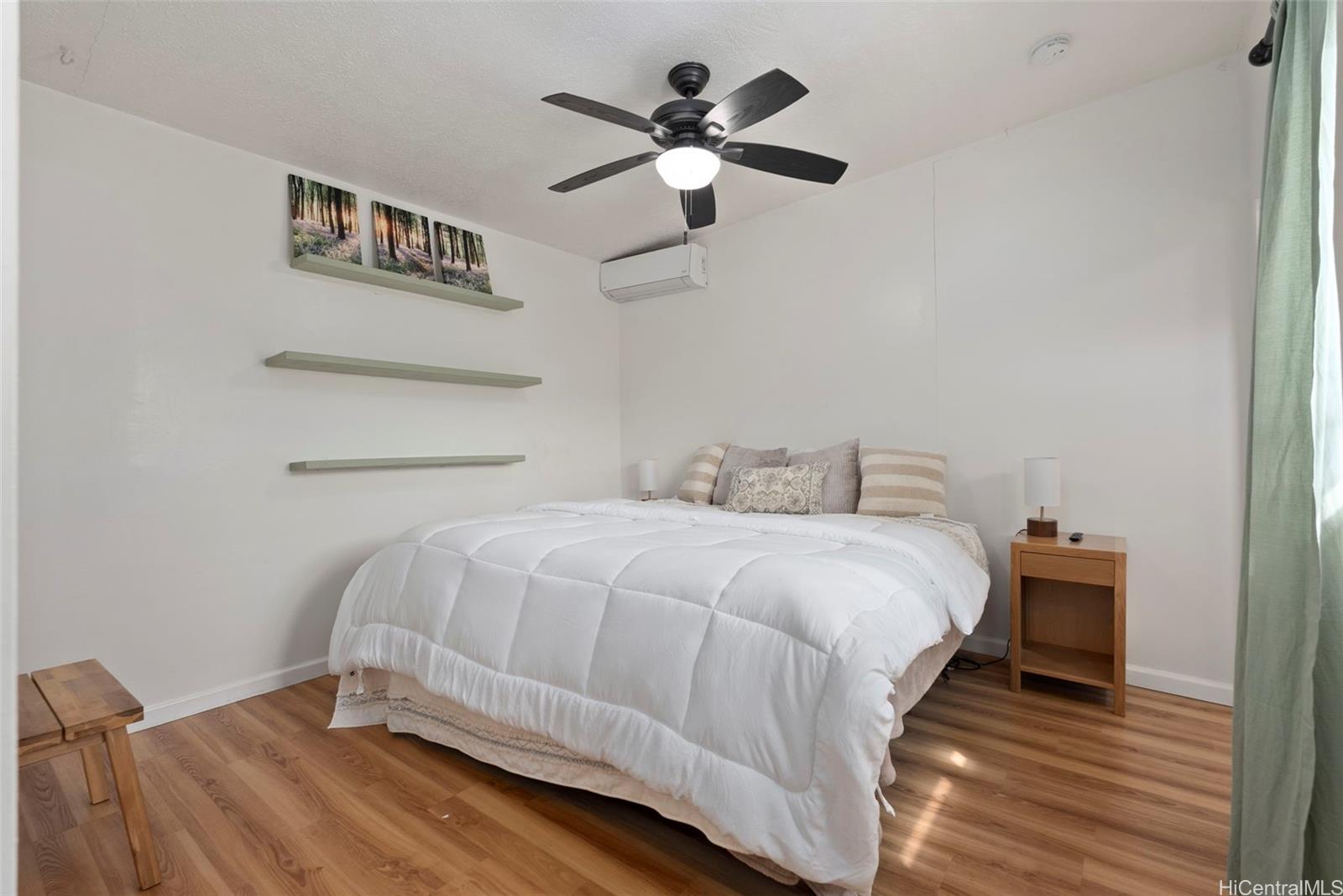 87-1423 Akowai Road Waianae, HI 96792 - Photo 15 of 24 a bedroom with bed and a chandelier