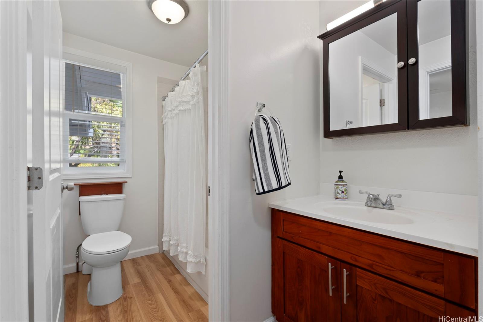 87-1423 Akowai Road Waianae, HI 96792 - Photo 17 of 24 a bathroom with a toilet sink and mirror