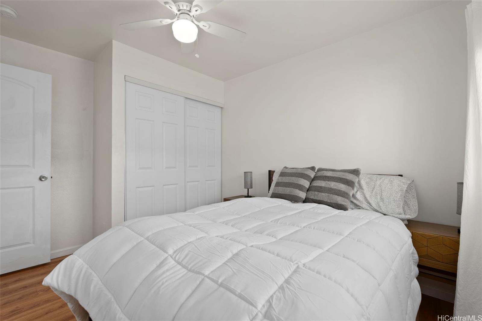 87-1423 Akowai Road Waianae, HI 96792 - Photo 18 of 24 a bedroom with a bed and a chandelier