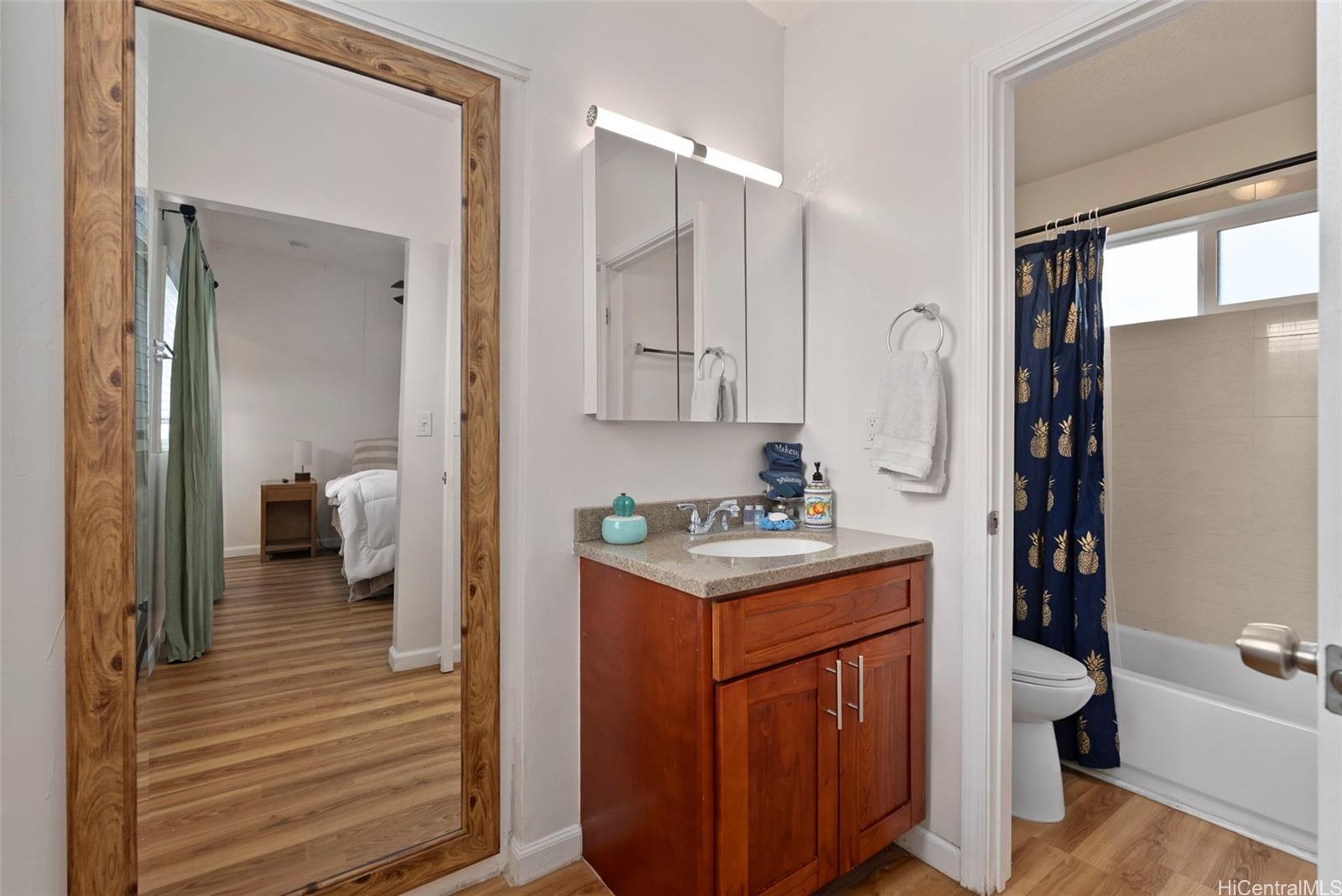 87-1423 Akowai Road Waianae, HI 96792 - Photo 19 of 24 a en suite bathroom with a toilet sink and mirror