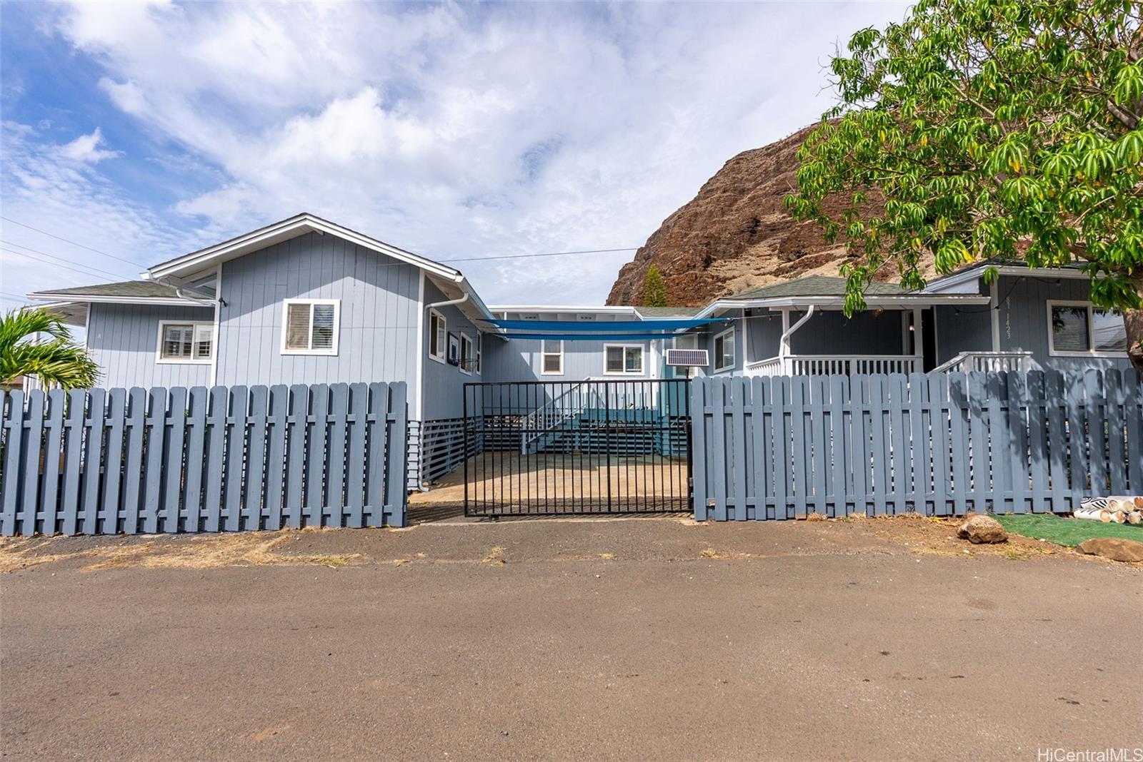 87-1423 Akowai Road Waianae, HI 96792 - Photo 20 of 24 a view of a house with a wooden fence