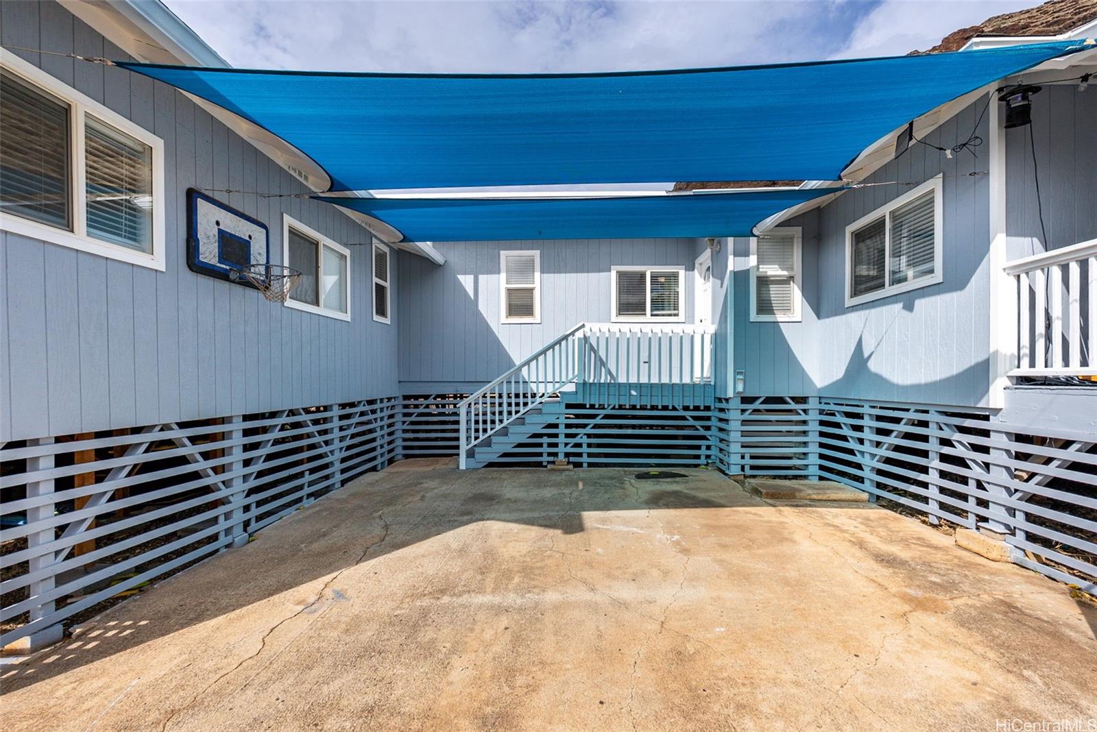 87-1423 Akowai Road Waianae, HI 96792 - Photo 21 of 24 a front view of a house with a yard