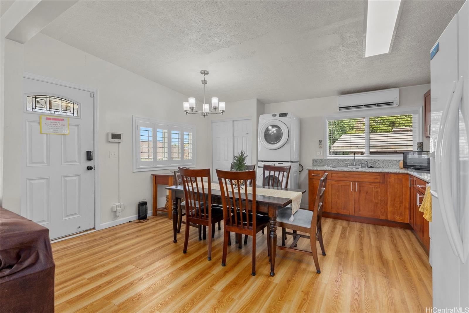 87-1423 Akowai Road Waianae, HI 96792 - Photo 4 of 24 a dining room with furniture a chandelier and wooden floor
