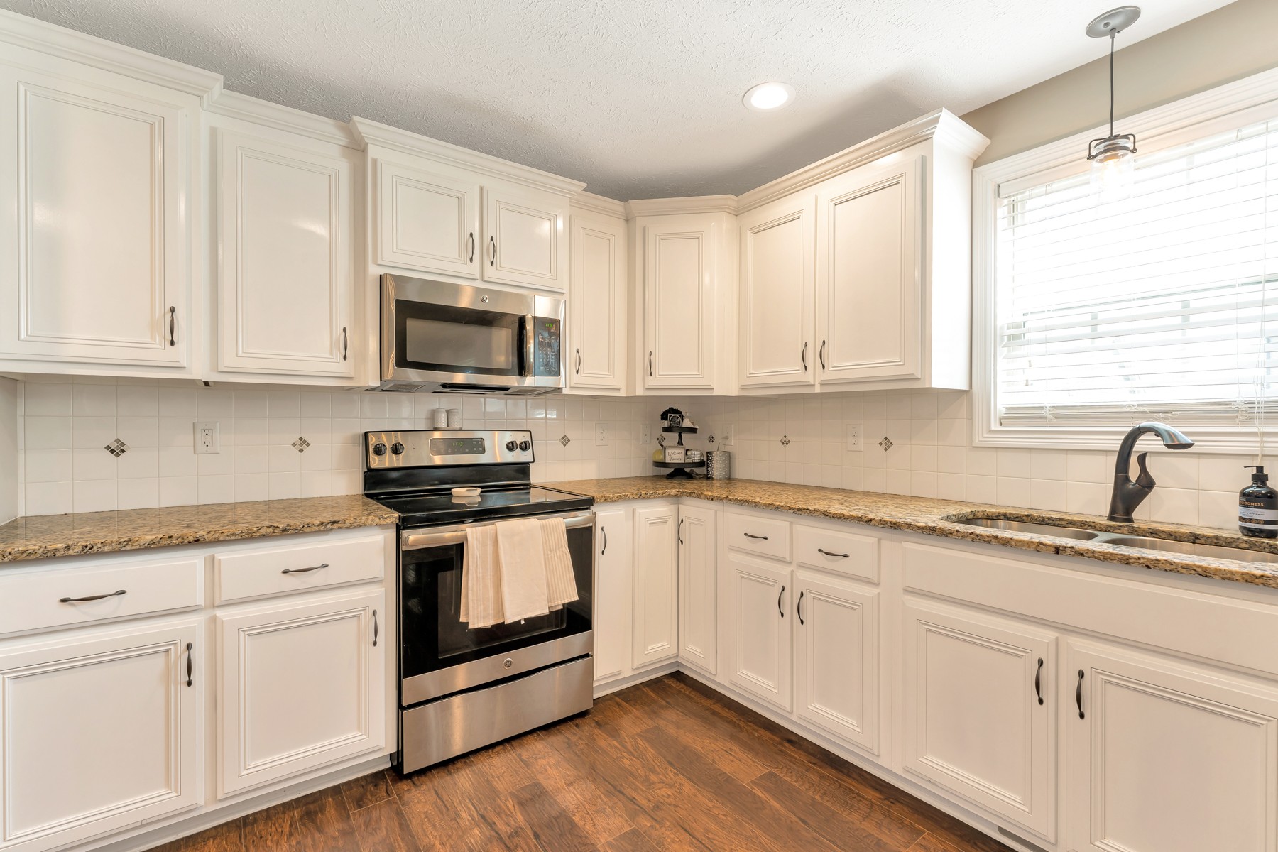 723 Backwind Lane Clarksville, TN 37040 - Photo 11 of 29 a kitchen with granite countertop white cabinets and white appliances