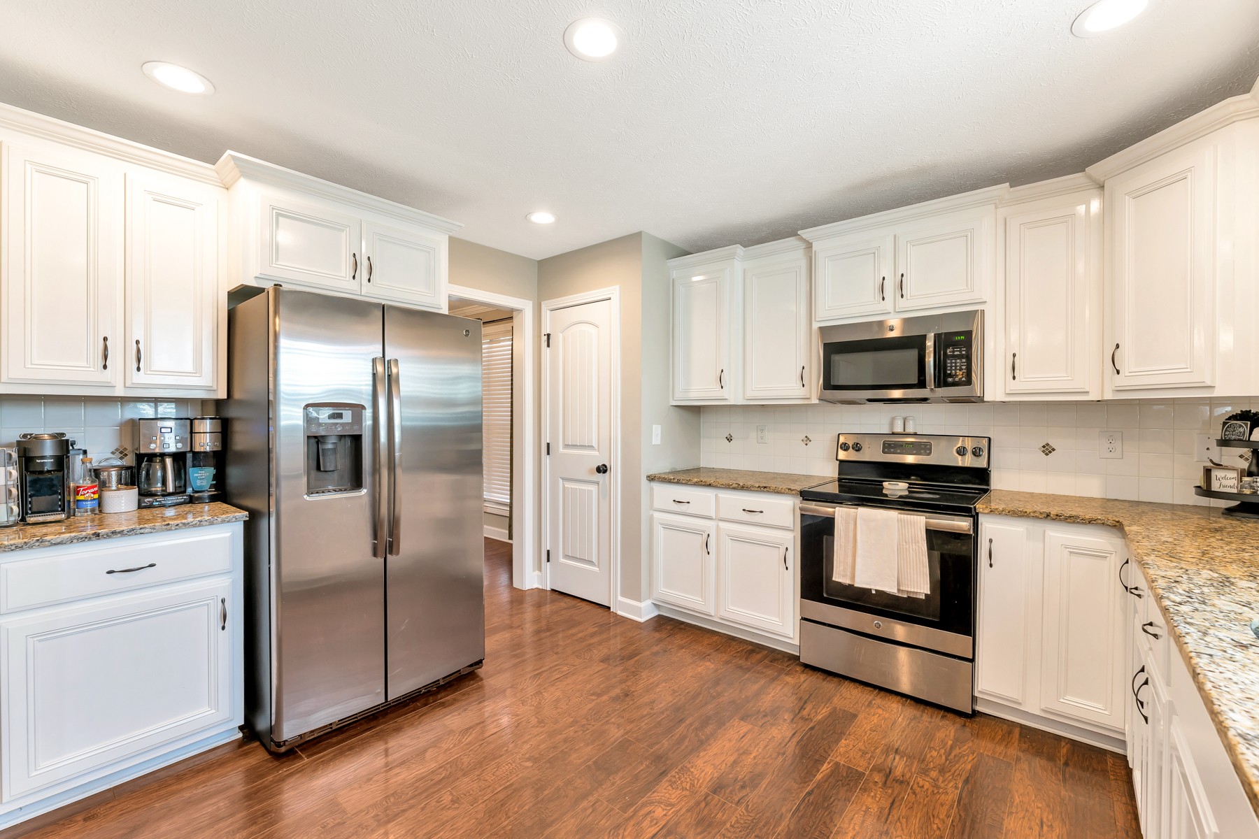 723 Backwind Lane Clarksville, TN 37040 - Photo 12 of 29 a kitchen with stainless steel appliances cabinets a wooden floor and a sink