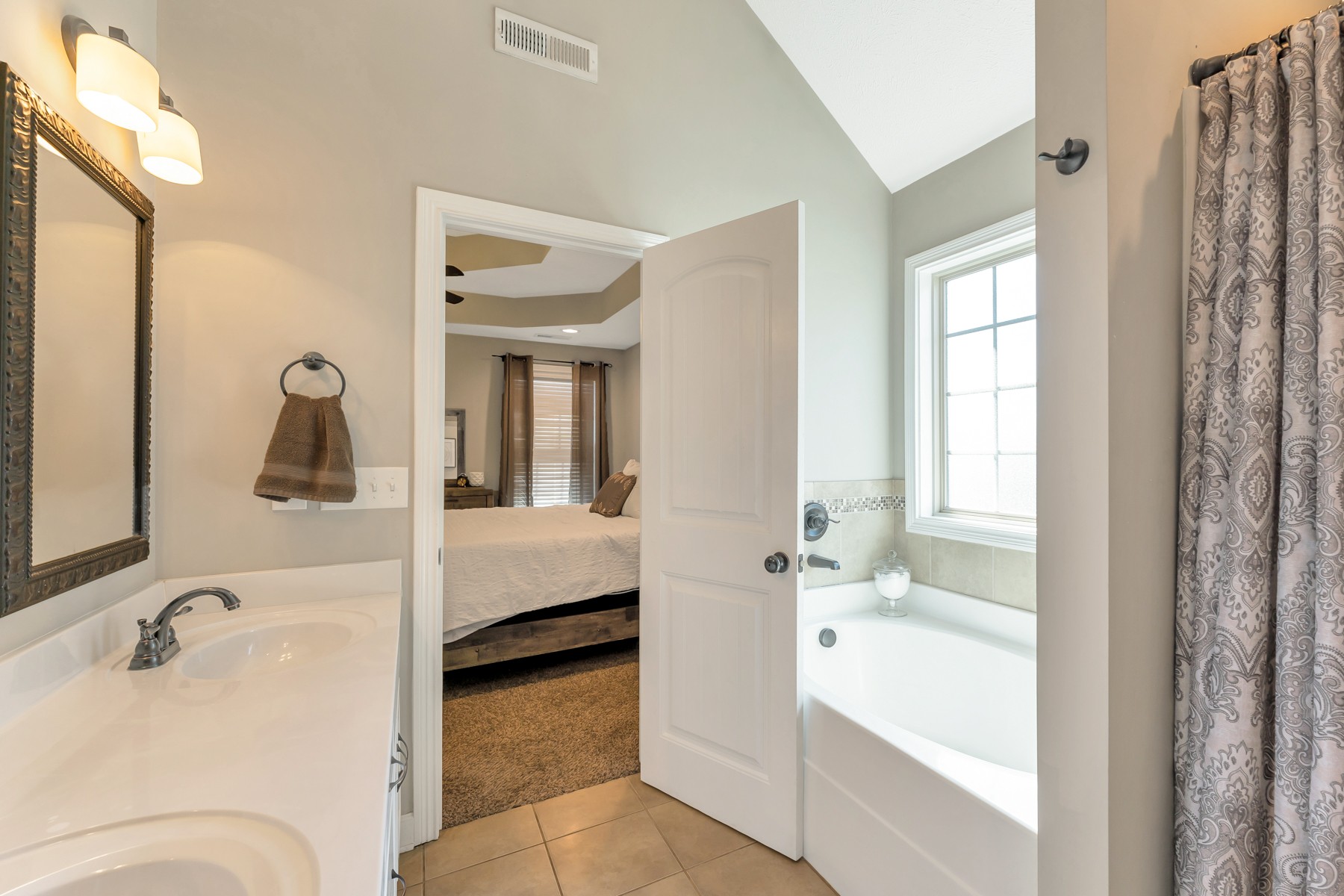 723 Backwind Lane Clarksville, TN 37040 - Photo 20 of 29 a en suite bathroom with a tub sink and mirror