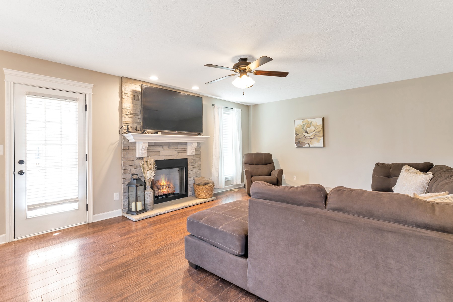 723 Backwind Lane Clarksville, TN 37040 - Photo 5 of 29 a living room with furniture a flat screen tv and a fireplace