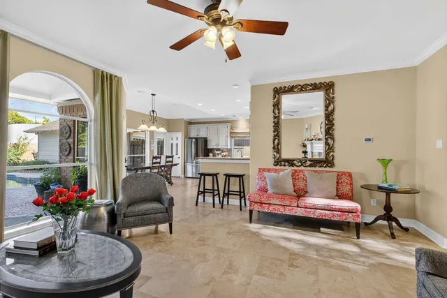 a living room with furniture fireplace and a large window