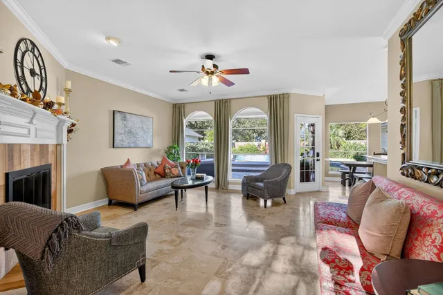 a kitchen with stainless steel appliances kitchen island granite countertop a table chairs and a refrigerator